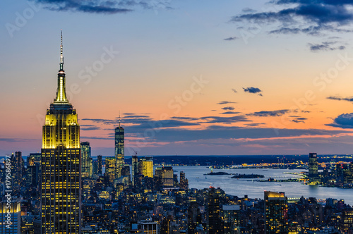 City skyline and Empire State Building at night in NYC, USA