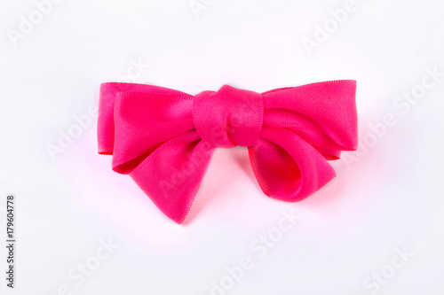Pink bow tie on white background. Beautiful accessory for girls hair isolated on white bakground. Kids elegant hair accessory.