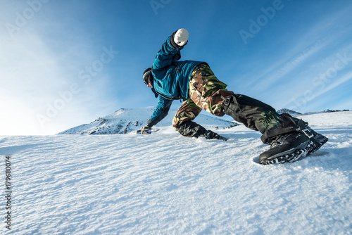 climber with an ice ax climb on the snowy mountain