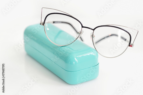 Glasses case with fashionable glasses on white background