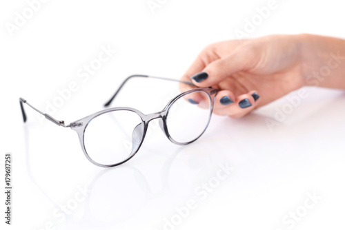 Beautiful glasses whit female hand on white background