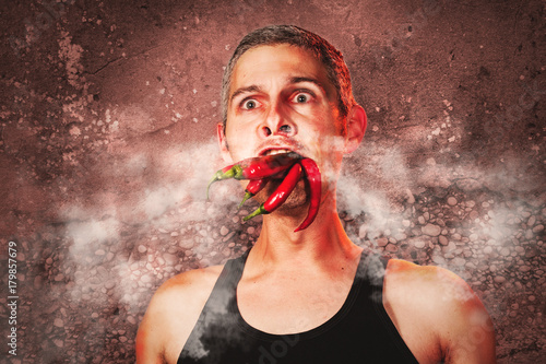 ridiculous expression of a man with hot chillies in his mouth