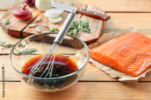 Soy marinade for salmon and fillet on wooden table