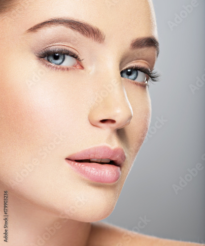 Beautiful face of young woman with perfect skin