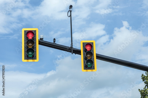 red traffic light at hanging lamp under sky