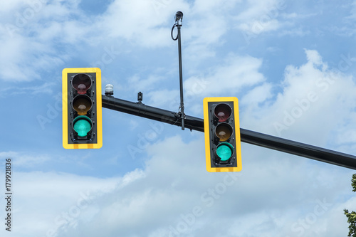 green traffic light at hanging lamp under sky