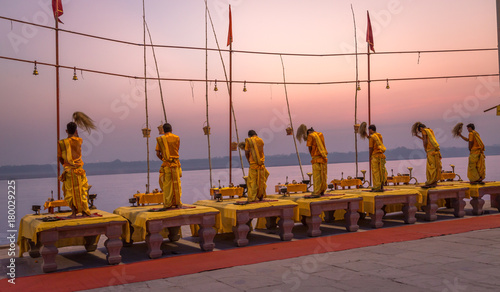 Ganga aarti ceremony ritual performed by priests at the Ganges river bank Varanasi India at dawn.