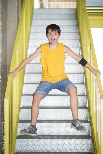 A teenager jumping on the stairs and smiling