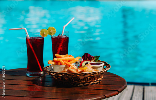 fish and chips with drinks served on tropical beach