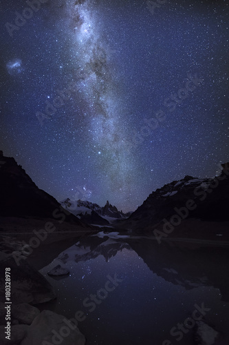 Fantastic quiet starry night on the glacial lake near Mountain peak Cerro and Lagoon Torre. Milky Way and the Magellanic Cloud. Patagonia, Argentina, Andes.