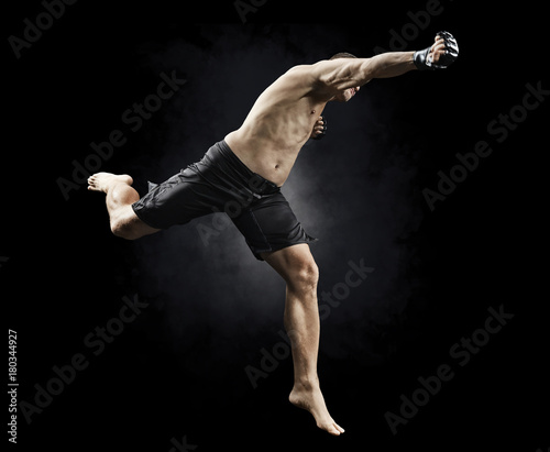 mma male fighter jumping to punch