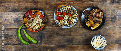 Vegetarian barbecue dinner. Various vegetarian snacks on a wooden table