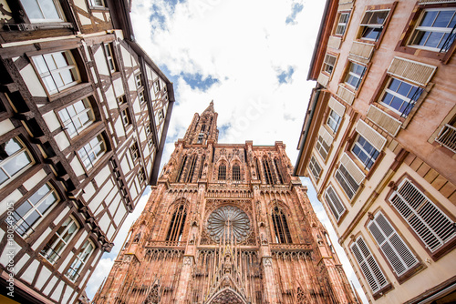 Street view from below on the beautiful old buildings and Notre-Dame cathedral in Strasbourg city, France