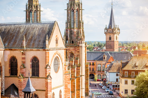 Cityscape view on the old cathedral and tower in Obernai village during the sunny day in Alsace region, France