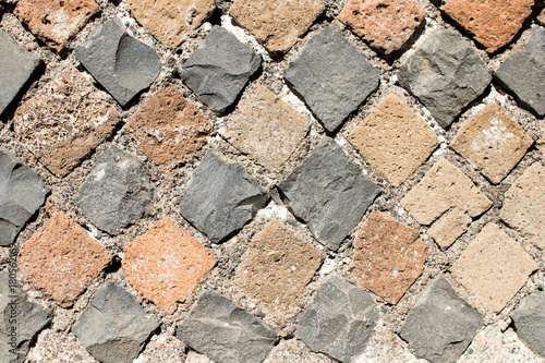 Detail of perimeter wall of a house of ancient Rome with the layout of the brickwork that follows the technique of Opus Reticolatum