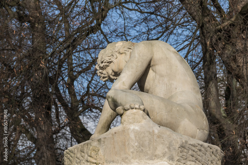 Sculpture of The Dying Gladiator, showing a naked wounded man with the neck torc, 1783 by Franciszek Pinck in the Royal Baths Park, Warsaw, Poland