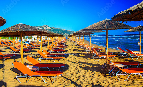Umbrellas and sundecks of the sandy Banana Beach on Zakynthos, Greece. Banana is the largest beach of Zakynthos island.