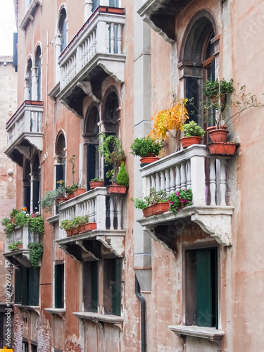 Balconies, windows and flowers along a canal in Venice