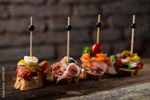 Tapas on Crusty Bread - Selection of Spanish tapas served on a sliced baguette.