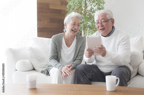 An old couple enjoying tablets