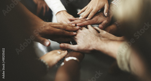 People with joined hands as a team