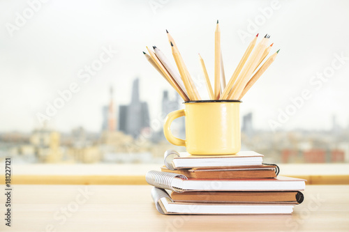 Iron mug with pencils and diary