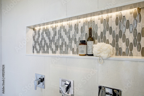 Stunning walk-in shower with white tile surround.