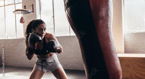 Female boxer training inside a boxing ring