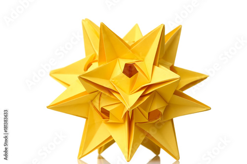 Yellow star origami figurine isolated on white background. Astronomical bodies. Fancy artwork, school project.