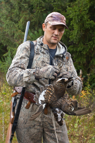 hunter with hunting trophy - black grouse