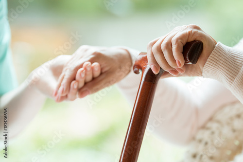 Elder person supported on stick