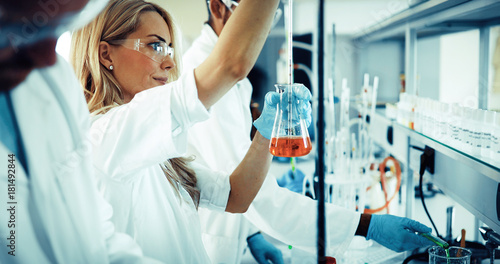 Attractive student of chemistry working in laboratory