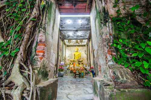 Unidentified people pray golden Buddha statue inside the ancient temple of Wat Bang Kung , founded in 1707, at Amphawa on Aug 21, 2017 in Samut Songkhram, Thailand.