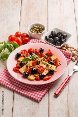 tofu salad with tomatoes black olives capers and pistachio