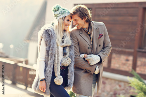 Happy couple walking outdoors in winter