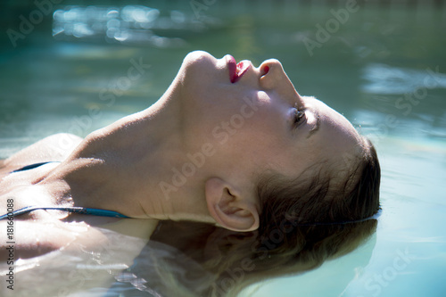 young beautiful sexy woman close-up swimming in the pool