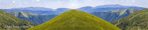 Panorama of green hills in summer mountains