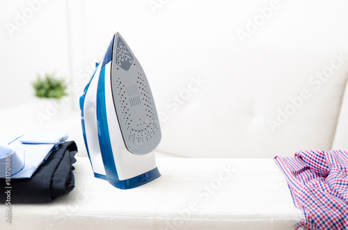 Steam blue iron on ironing board