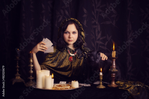 Young woman with divination cards in room