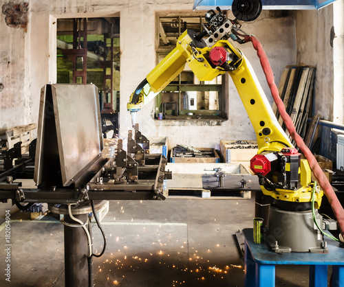 Welding robot in operation / Photo taken in Russia, in factory premises