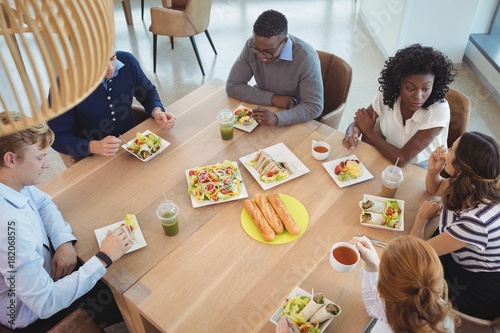 Business coworkers having breakfast at office cafeteria