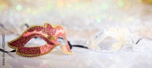 Pink carnival mask on bokeh background