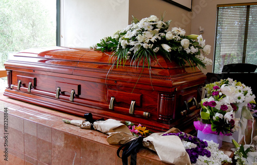 closeup shot of a colorful casket in a hearse or chapel before funeral or burial at cemetery