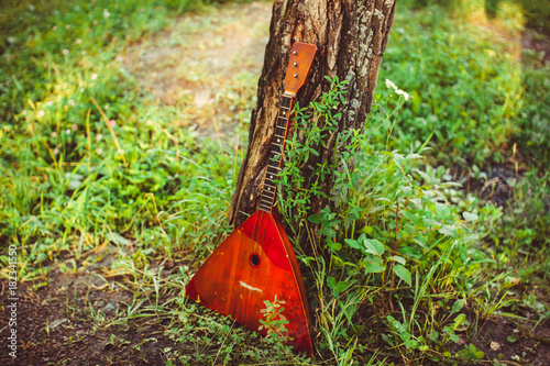 Folk musical instrument balalaika on wooden background