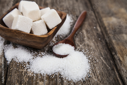 Bowl with sugar and a wooden spoon