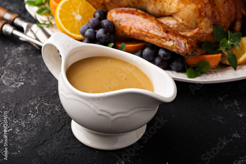 Homemade gravy in a sauce dish with turkey