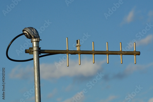 UHF yagi antenna used for digital telemetry data as late afternoon sun setting gives antenna a golden tone