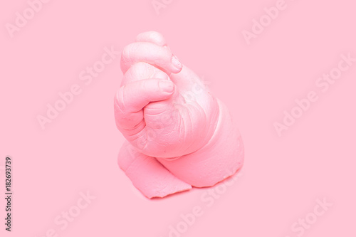 Pink ceramic plaster cast of a hand, art sculpture in pink