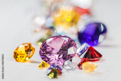 colorful gemstones are displayed on the white floor