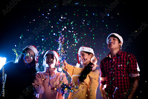 Group of Asian people celebrating New year party in night club. New year and Christmas party concept. Happiness and Entertainment concept. Night pub and Night life theme.